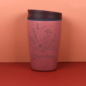 Personalized Owala SmoothSip coffee cup with a custom name and engraved moon floral design. The wildflower and celestial artwork creates a charming everyday bottle for hot or cold drinks, making it a memorable birthday gift, best friend gift, or unique customized drinkware piece for someone special.