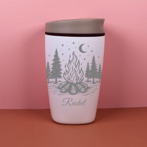 Custom engraved Owala SmoothSip cup with a starry night camping theme, complete with celestial details and outdoor charm. The personalized name design makes this travel coffee cup perfect for coffee on the go, cozy cabin mornings, camping trips, road trips, or a unique gift for her.
