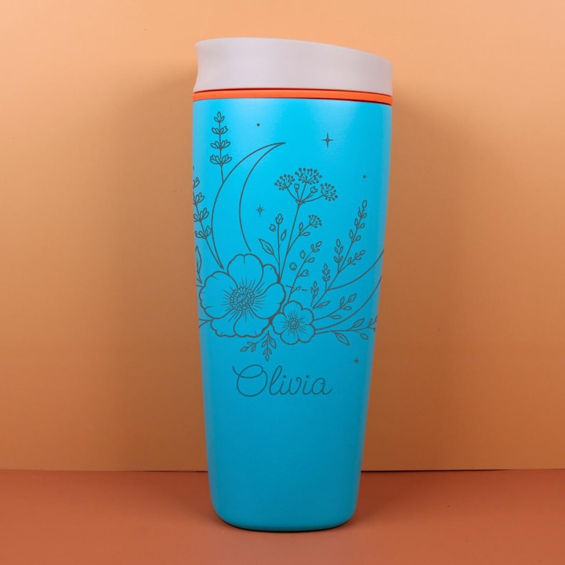 Engraved Owala SmoothSip bottle with a custom name surrounded by delicate wildflowers, moon details, and celestial accents. The design has a dreamy whimsical style that makes it a beautiful personalized birthday gift, best friend gift, or cozy travel coffee cup for daily use at work, school, or on the go.