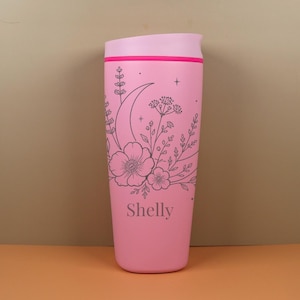 Whimsical Owala SmoothSip travel coffee cup engraved with a custom name and moon wildflower design. This personalized bottle has a soft celestial floral style that makes it perfect for gifting to a best friend, sister, mom, coworker, or birthday girl who loves cozy and meaningful accessories.
