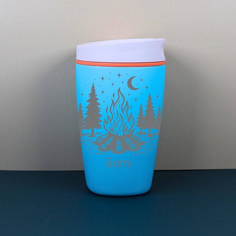 Personalized travel coffee cup designed with a whimsical outdoor camping scene and celestial starry night details. This engraved Owala SmoothSip makes a beautiful custom gift for her, blending practical drinkware with cozy campfire energy, nature-inspired style, and personalized charm.