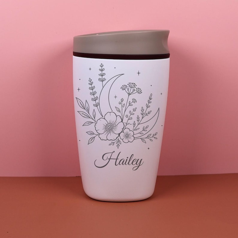 Custom name Owala SmoothSip travel coffee cup featuring a laser engraved moon floral design with wildflowers and celestial elements. This personalized bottle offers a sweet mix of boho, cottagecore, and magical style, making it a charming gift for a best friend, sister, teacher, coworker, or birthday celebration.