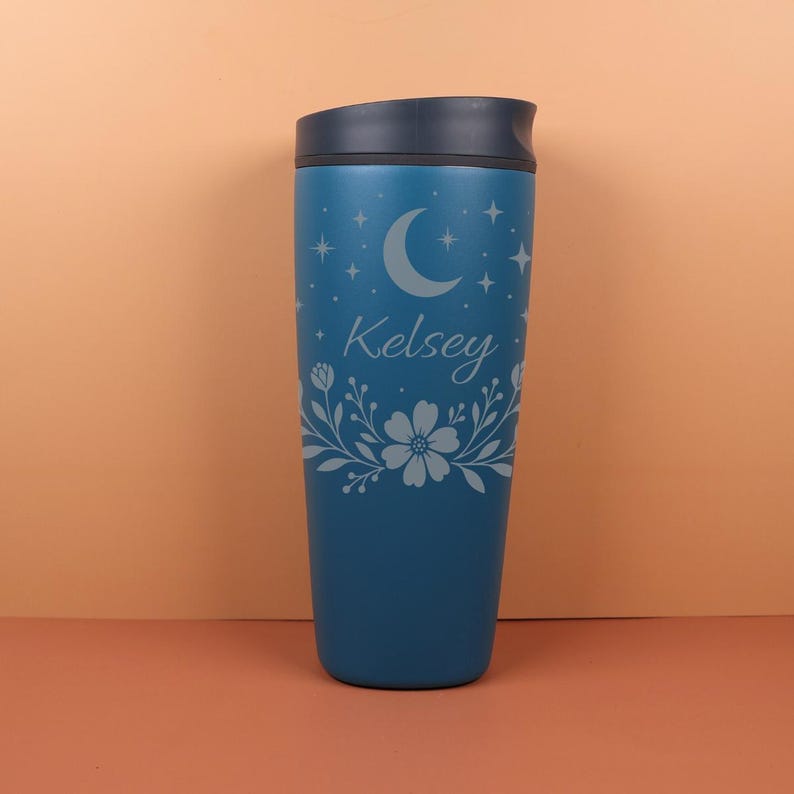Flat lay of a personalized SmoothSip bottle with custom name text and celestial artwork, including stars and crescent moons, styled with dried flowers to emphasize its boho, whimsigoth aesthetic.