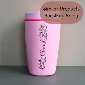 May include: A pink travel mug with a light purple lid and a red accent. The mug features a floral design and the name "Cheryl" in a script font. The text "Similar Products You May Enjoy" is in a brown oval.