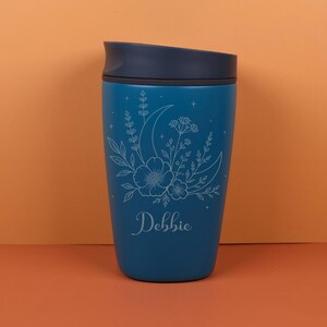 Personalized engraved Owala SmoothSip bottle with custom name, moon details, and delicate wildflowers. The celestial floral design gives this travel coffee cup a magical cottagecore look, making it a thoughtful birthday gift, friendship gift, or everyday cup for someone who loves unique drinkware.