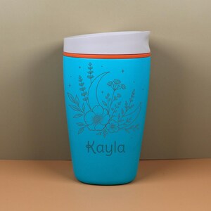 Custom engraved Owala SmoothSip bottle with a dreamy moon and floral wildflower design. The personalized name detail makes this travel coffee cup feel one of a kind, while the celestial artwork adds a whimsical touch for best friends, moms, sisters, coworkers, teachers, or birthday gift recipients.