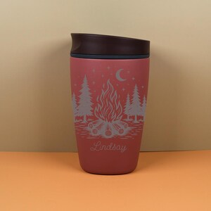 Engraved Owala SmoothSip cup featuring a custom name and celestial camping artwork inspired by starry skies, campfire nights, and outdoor adventures. This personalized travel cup is a sweet choice for camping gifts, birthday gifts, holiday presents, or cozy everyday drinkware.