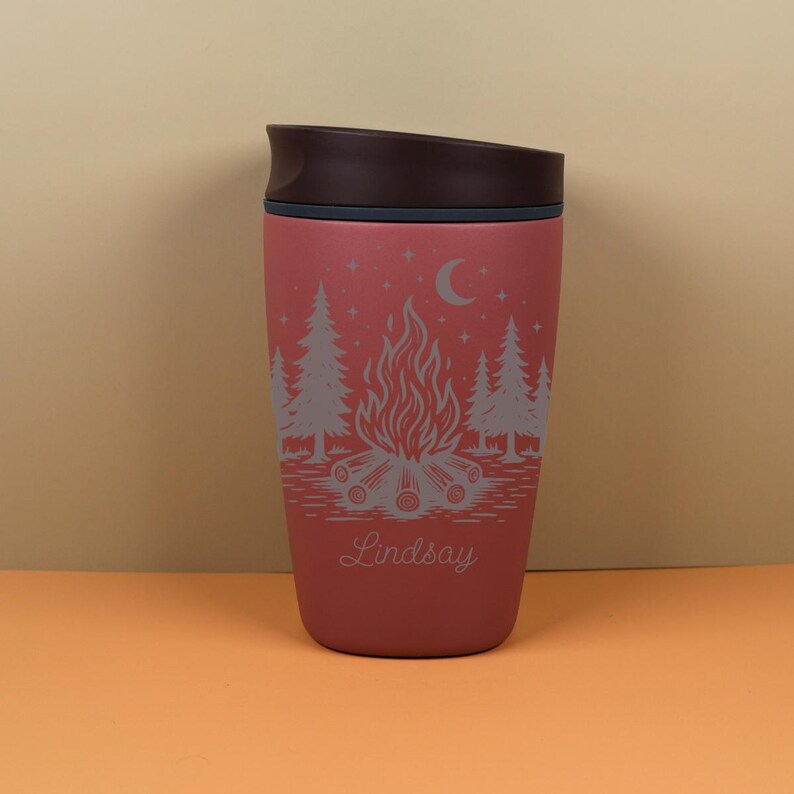 Engraved Owala SmoothSip cup featuring a custom name and celestial camping artwork inspired by starry skies, campfire nights, and outdoor adventures. This personalized travel cup is a sweet choice for camping gifts, birthday gifts, holiday presents, or cozy everyday drinkware.