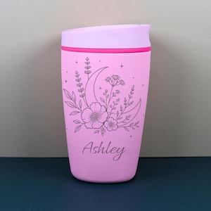 Personalized Owala SmoothSip travel coffee cup with a moon and wildflower inspired engraved design, featuring a custom name for a thoughtful celestial gift. This whimsical bottle blends floral cottagecore charm with cozy everyday function, perfect for birthdays, best friends, coworkers, or anyone who loves magical drinkware.