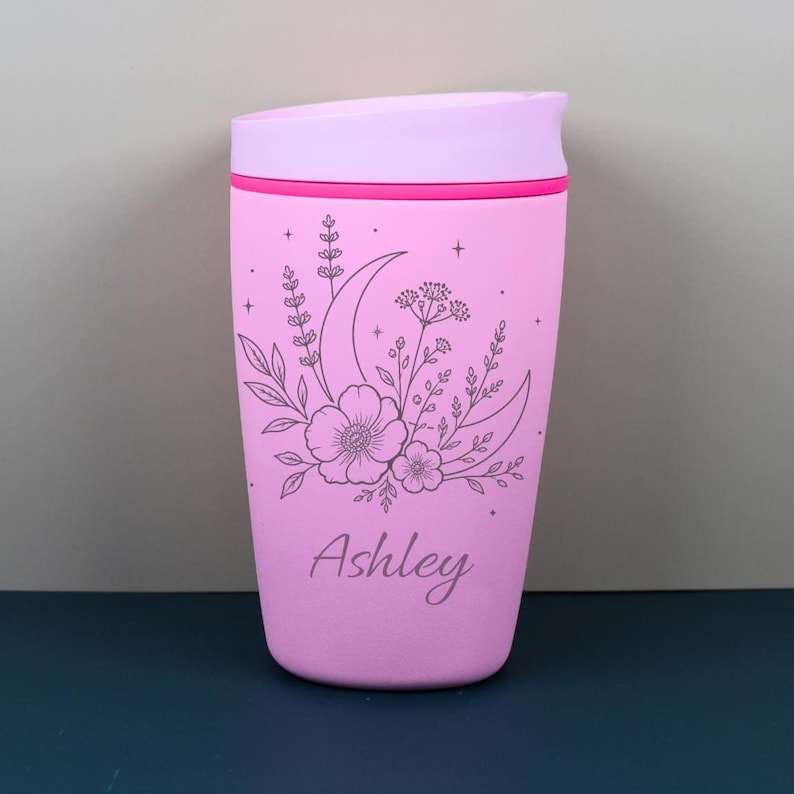 Personalized Owala SmoothSip travel coffee cup with a moon and wildflower inspired engraved design, featuring a custom name for a thoughtful celestial gift. This whimsical bottle blends floral cottagecore charm with cozy everyday function, perfect for birthdays, best friends, coworkers, or anyone who loves magical drinkware.