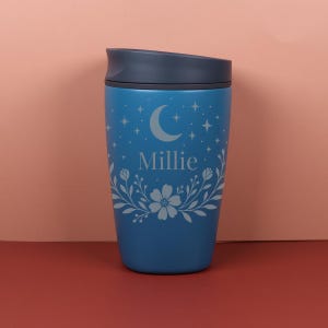 A personalized Owala SmoothSip bottle with a custom name surrounded by a mix of wildflowers and subtle star patterns, combining cozy cottagecore charm with a celestial-inspired design.