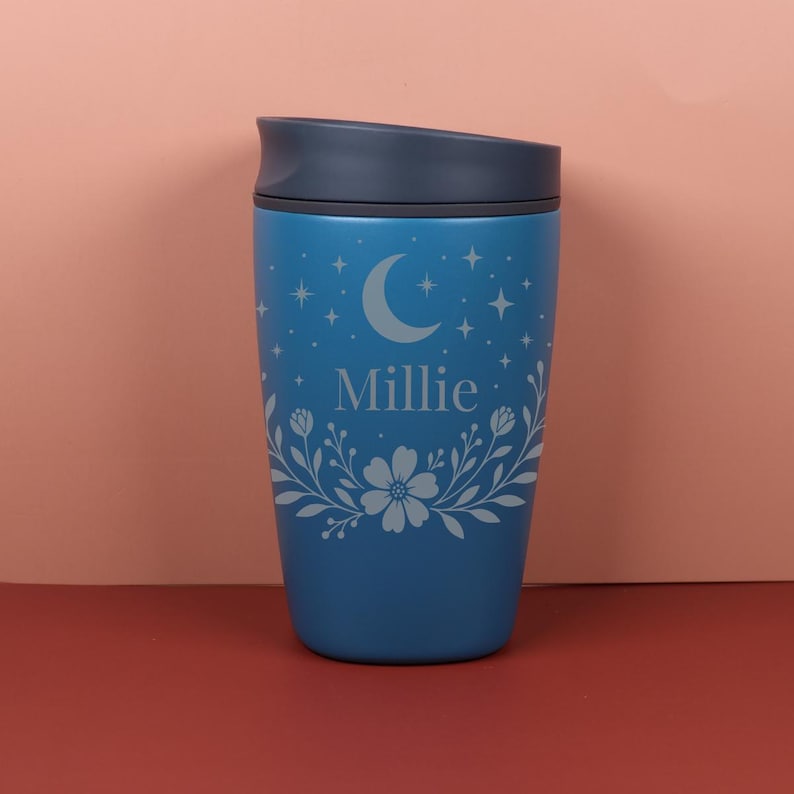 A personalized Owala SmoothSip bottle with a custom name surrounded by a mix of wildflowers and subtle star patterns, combining cozy cottagecore charm with a celestial-inspired design.