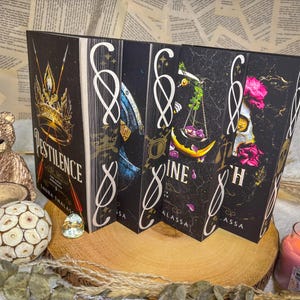May include: A set of five hardcover books with black covers and gold lettering. The titles are "PESTILENCE", "WAR", "Famine", "Death", and "Conquest". Each book features a unique illustration on the cover.
