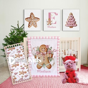 Pode incluir: Um conjunto de berçário com tema de pão de gengibre. Inclui um berço, roupa de cama e arte de parede com homens de gengibre, estrelas e árvores de Natal. O conjunto é decorado em rosa e branco, com o nome "Madison" no cobertor e na arte.