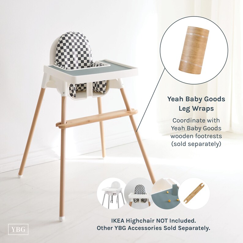 May include: A white highchair with wooden legs and a checkered seat and backrest. The highchair has a gray tray and a wooden footrest. The image also shows leg wraps and mentions coordinating wooden footrests.