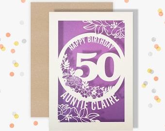 May include: A purple and white birthday card with a floral design and the text "Happy Birthday 50 Auntie Claire".