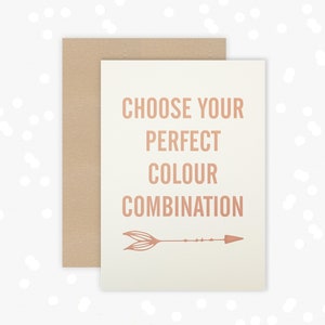 May include: A white card with the text "Choose your perfect colour combination" in a copper-colored font. An arrow with a feather design is below the text.