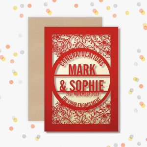 May include: Red laser cut card with a floral design and the text "Congratulations Mark & Sophie on your engagement 21st November 2023".