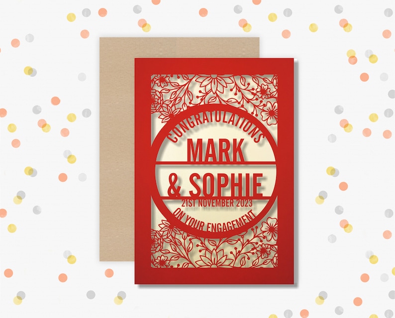 May include: Red laser cut card with a floral design and the text "Congratulations Mark & Sophie on your engagement 21st November 2023".