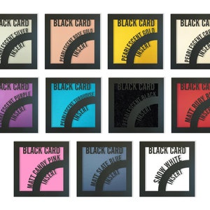 May include: Twelve small, square, black-framed cards with different colored inserts. Each card has the text "BLACK CARD" at the top and "INSERT" at the bottom. The inserts are in various colors, including silver, gold, cream, purple, turquoise, black, red, pink, blue, and white.