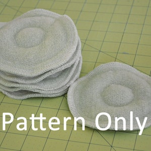 May include: A stack of grey fabric circles with a raised centre, and a single circle lying flat. The text "Pattern Only" is printed below the circles.