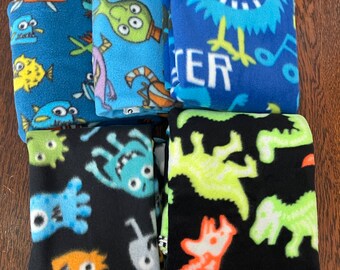 Fleece fabric stash, multiple monster / dinosaur prints.