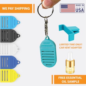 May include: A turquoise blue diffuser with a vent adapter and a small bottle of essential oil. The diffuser is attached to a silver keychain. The text "LIMITED TIME ONLY! CAR VENT ADAPTER" and "FREE ESSENTIAL OIL SAMPLE" is visible in the image.