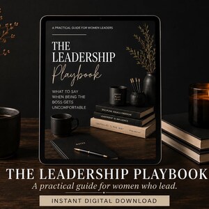 May include: A digital tablet displaying a book cover titled The Leadership Playbook: A Practical Guide for Women Leaders, featuring text about navigating uncomfortable boss situations, alongside a black mug, notebook, and stacked books.
