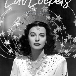 May include: Black and white image of a woman wearing a star-shaped headpiece, necklace, and earrings. The white dress is adorned with star-shaped embellishments. The text "Luv Lockets" is at the top of the image.
