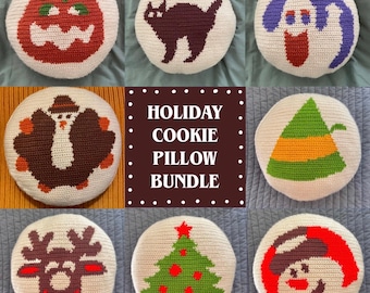 May include: A collection of round, cream-colored crochet pillows with holiday-themed designs. The designs include a pumpkin, black cat, ghost, turkey, elf hat, reindeer, Christmas tree, and snowman. The text "HOLIDAY COOKIE PILLOW BUNDLE" is also visible.