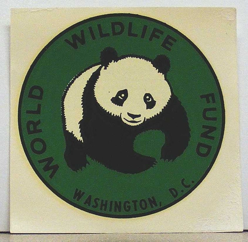 May include: A square sticker featuring a circular green emblem with a black border. Inside the circle is a black and white illustration of a giant panda. The text "WORLD WILDLIFE FUND" and "WASHINGTON, D.C." is printed in black along the border.