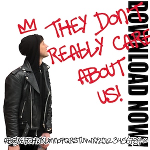 May include: A person wearing a black leather jacket and a black hooded sweatshirt stands in front of a white wall with red spray paint writing that says "They Don't Really Care About Us!" and "Download Now" in black. The writing is in a graffiti style.