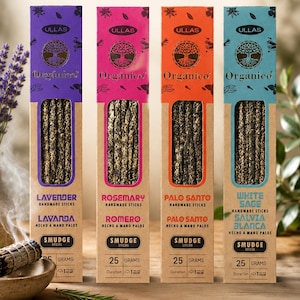 May include: Four boxes of handmade smudge sticks, each with a different color scheme. The boxes are labeled with the names of the herbs: Lavender, Rosemary, Palo Santo, and White Sage. Each box contains 25 grams of smudge sticks.