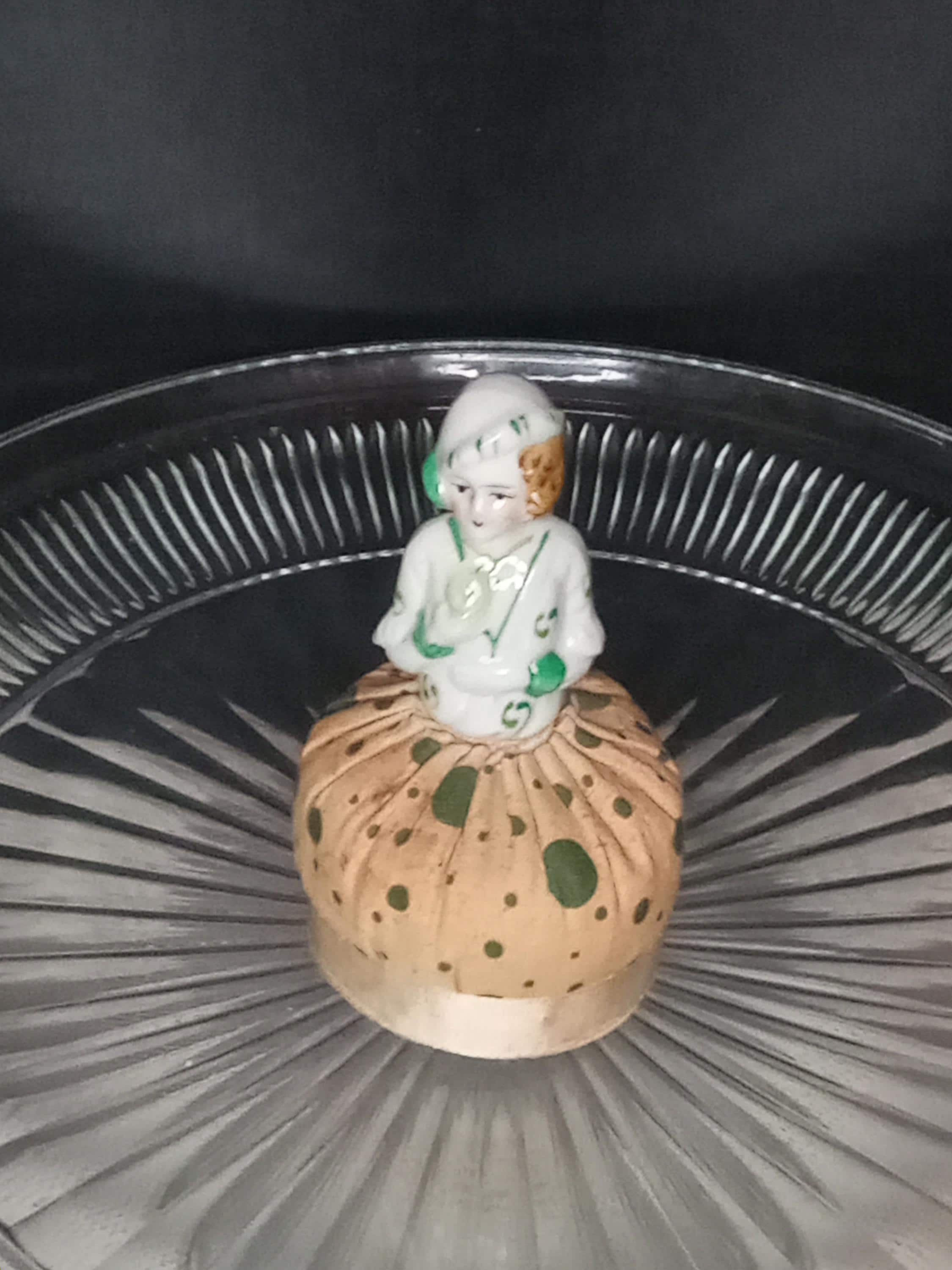Early Victorian Lady Pin Cushion. China Doll Top Nestled into a Firmly Stuffed Gown. Green Polka Dots. Ribbon around the Bottom.
