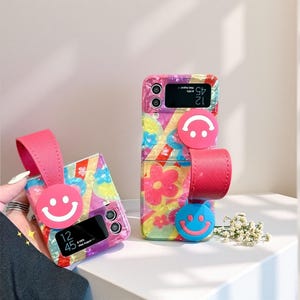 Korean Flower Smiley Wristband Case for Samsung Galaxy Z Flip6 5 4 3 – Cute Folding Screen Shockproof Phone Cover