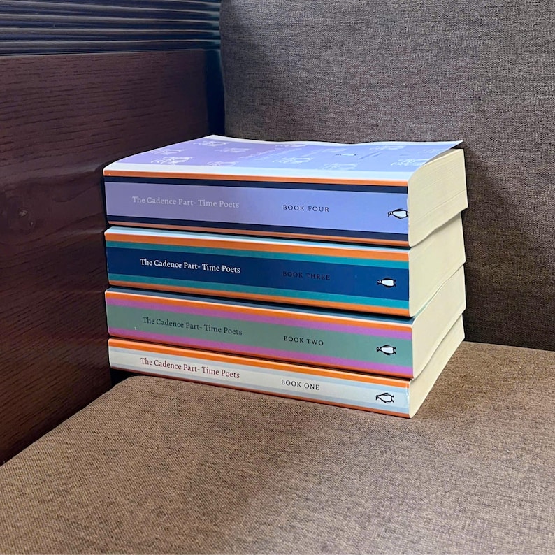 May include: A stack of four books titled "The Cadence Part-Time Poets" with colorful spines. Each book is labeled with a number: Book One, Book Two, Book Three, and Book Four. The books have a penguin logo.