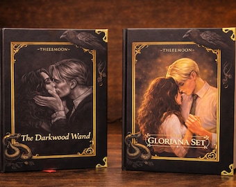 May include: Two hardback books with black covers and gold detailing. The book on the left is titled "The Darkwood Wand" and features an illustration of a couple kissing. The book on the right is titled "Gloriana Set" and shows a couple embracing.