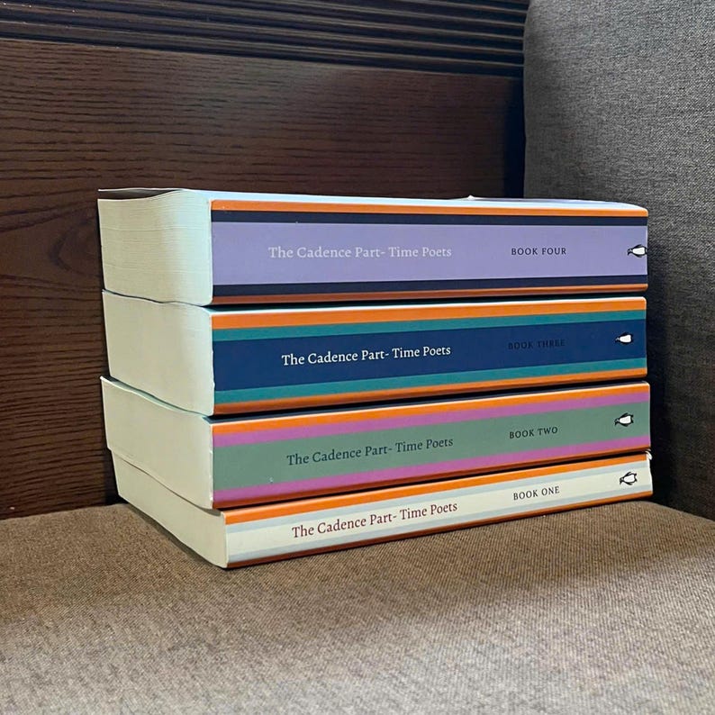 May include: A stack of four books titled "The Cadence Part-Time Poets." Each book has a different colored spine: purple, navy blue, green, and orange. The text "BOOK ONE," "BOOK TWO," "BOOK THREE," and "BOOK FOUR" is visible on the spines.