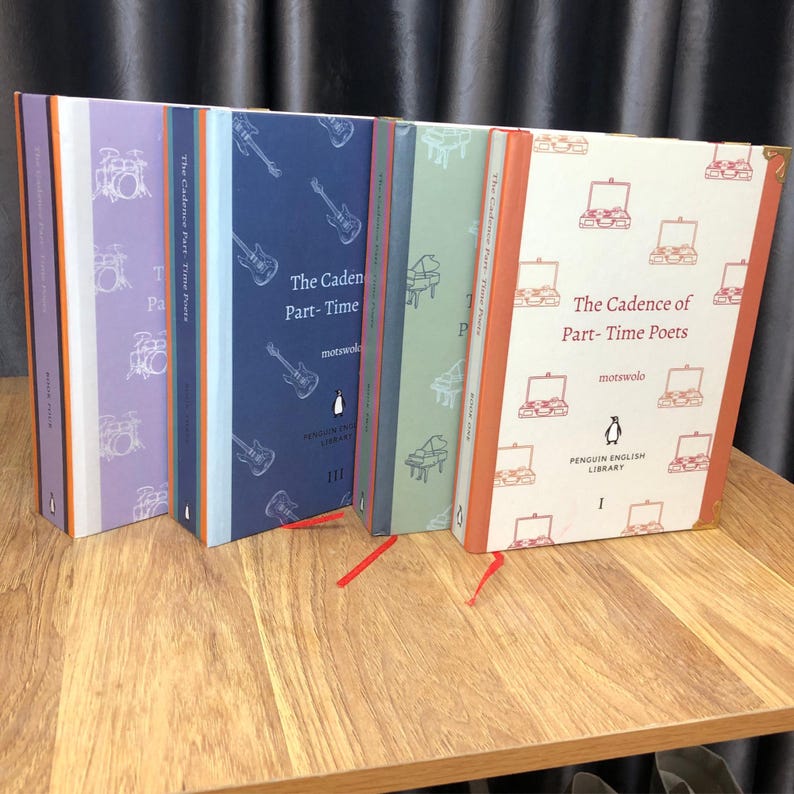 May include: A collection of Penguin English Library books titled "The Cadence of Part-Time Poets." The book covers feature musical instrument illustrations in various colors, including purple, blue, green, and cream. Each book has a different design and a red bookmark.