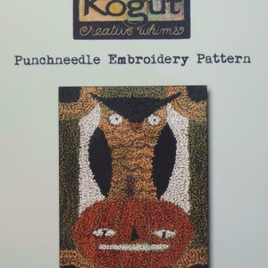 May include: A punchneedle embroidery pattern with a primitive owl and pumpkin design, measuring approximately 7.6 cm by 12.1 cm. The pattern includes the text "Teresa Kogut Creative Whims" and "Punchneedle Embroidery Pattern".