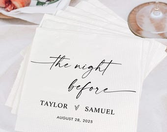 May include: A stack of white paper napkins with the text "the night before" in elegant script. Below the text are the names "Taylor" and "Samuel" with a heart symbol, and the date "August 28, 2025". Peaches, wine glasses, and grapes are in the background.