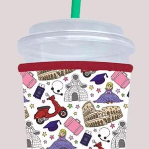 May include: A reusable travel-themed tumbler with a white lid and a green straw. The tumbler features a repeating pattern of red scooters, the Colosseum, graduation caps, and other travel icons.