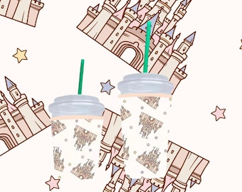 May include: Two clear plastic cups with lids and green straws. The cups are wrapped with a white paper design featuring a pink and blue castle with stars.