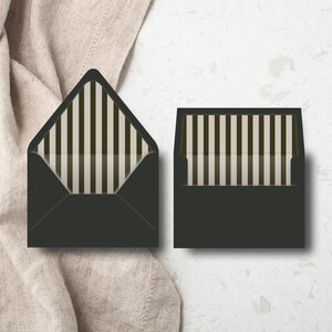 May include: Two black envelopes with a striped interior design. One envelope is open, revealing the interior pattern of vertical stripes in shades of green and white. The other envelope is closed, showing the same striped pattern.