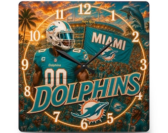 May include: A square wall clock featuring a Miami Dolphins football player in a teal uniform, a stadium background, a flag with the text MIAMI, and the word DOLPHINS in large teal letters. The clock face includes numbers 1 through 12 in a circle.