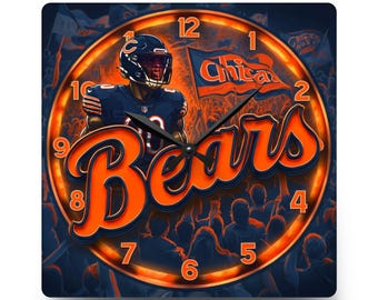 May include: A square wall clock featuring a Chicago Bears football player in a navy and orange uniform, a waving flag with the text Chicago, and the word Bears in large orange script. The clock face has orange numbers and black hands.