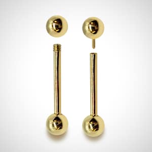 May include: A gold barbell with two round balls on either end. The barbell is disassembled, showing the two balls and the barbell itself.
