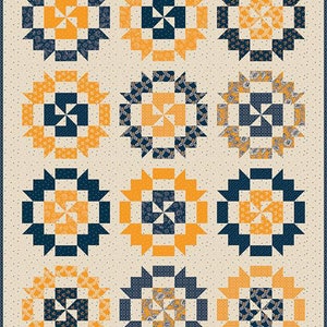 May include: A quilt with a repeating pattern of navy blue and orange squares arranged in a circular design. The background is a light beige with a subtle polka dot pattern.