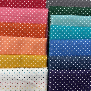 May include: A stack of fabric featuring various colors and white polka dots. The fabrics are arranged in a vertical stack, with the top fabric being a dark red color and the bottom fabric being a dark purple color.