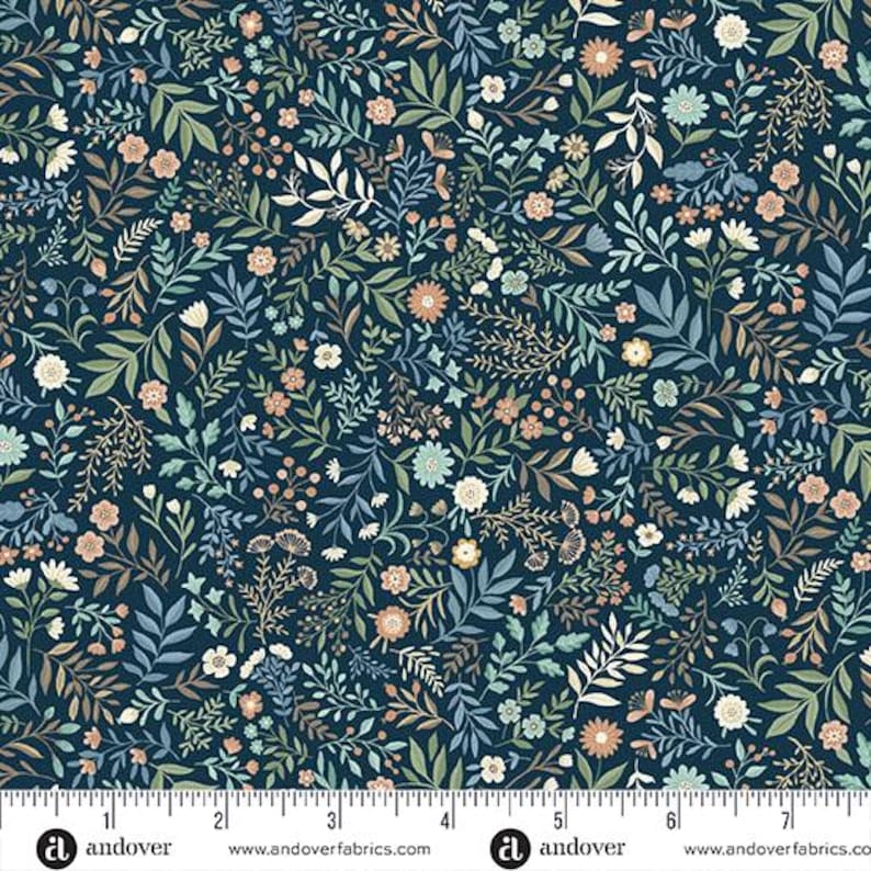 May include: A fabric with a dense floral pattern. The design features a dark blue background with an all-over print of various flowers, leaves, and vines in shades of white, peach, green, and blue. The fabric is marked with a ruler along the bottom edge.